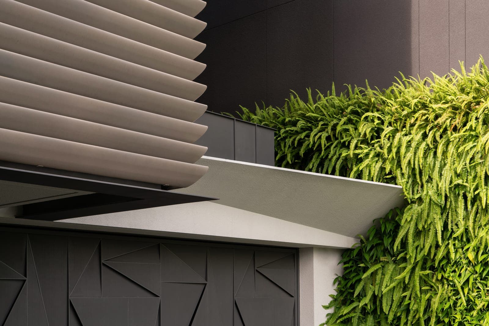 Where the louvres stop, a green wall takes over.