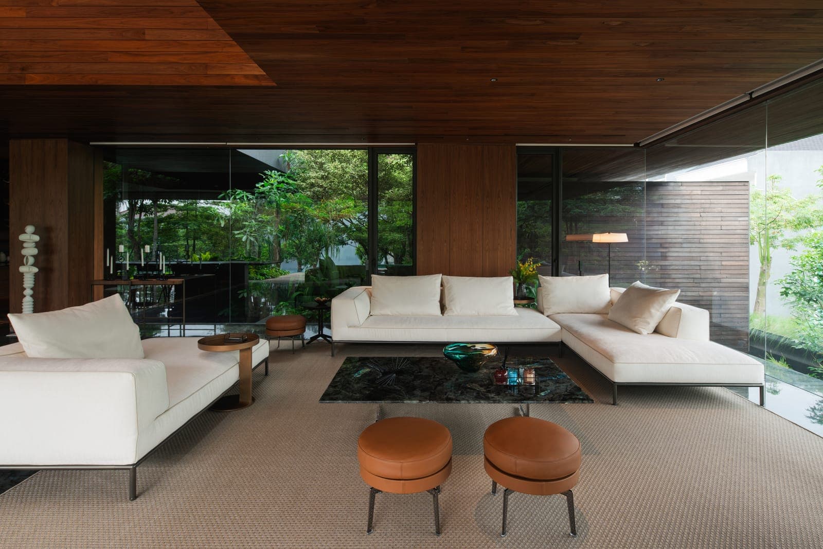 The living room, glazed to the trees.