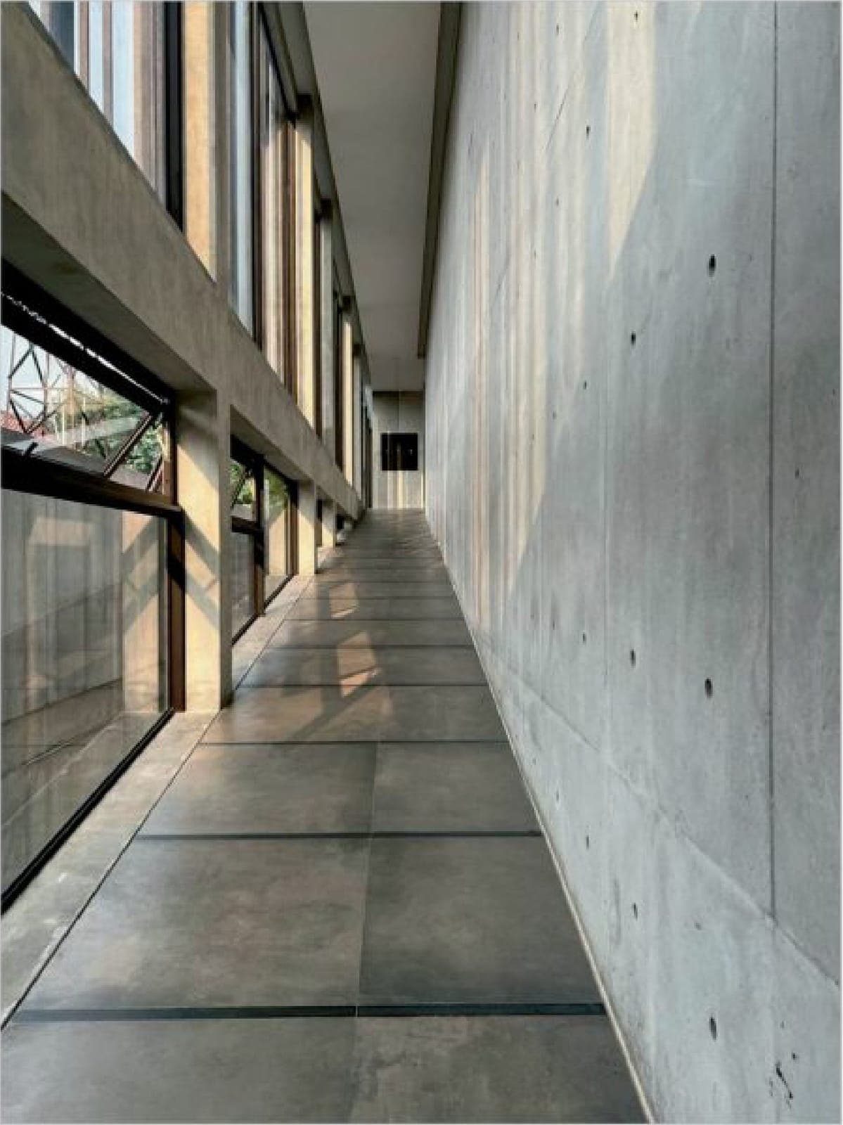 Top-lit corridors of board-formed concrete.