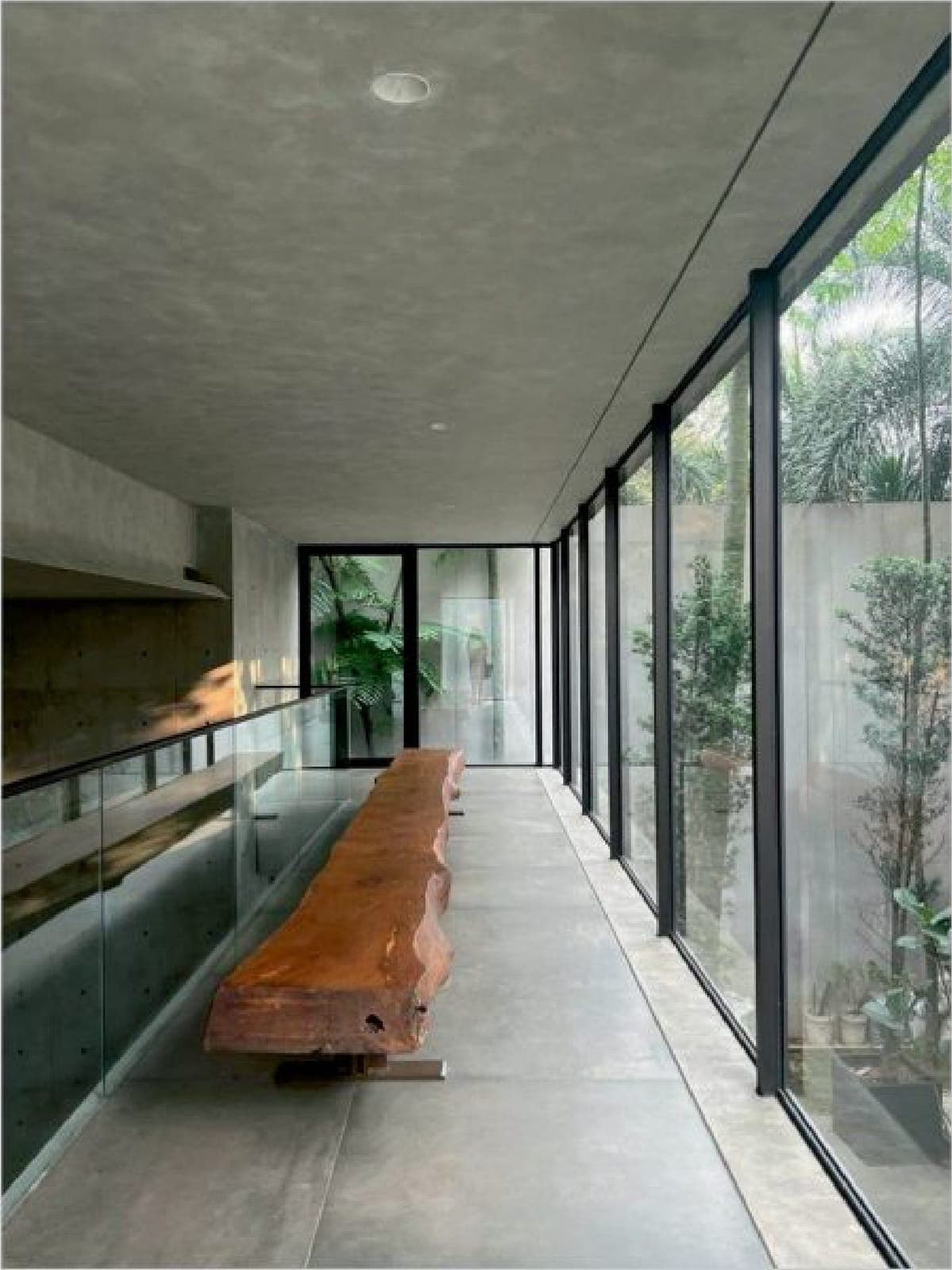 A live-edge bench runs the glazed gallery.