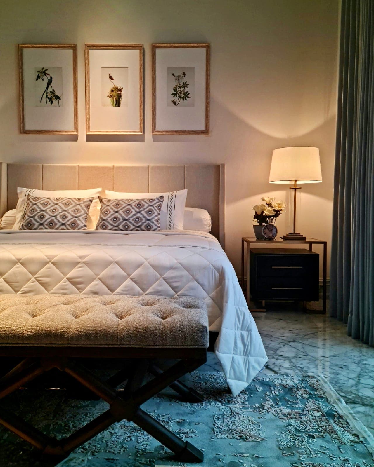 A bedroom, curtains drawn to the garden.