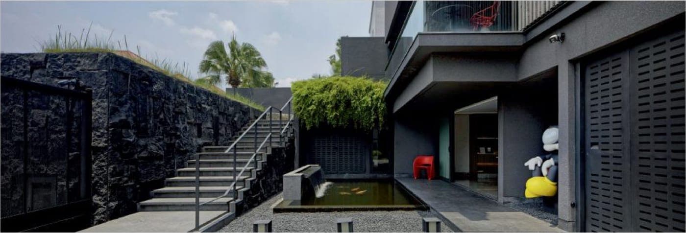 A sunken koi court in split stone; the door out to the stair runs on FREMO Contemporary.