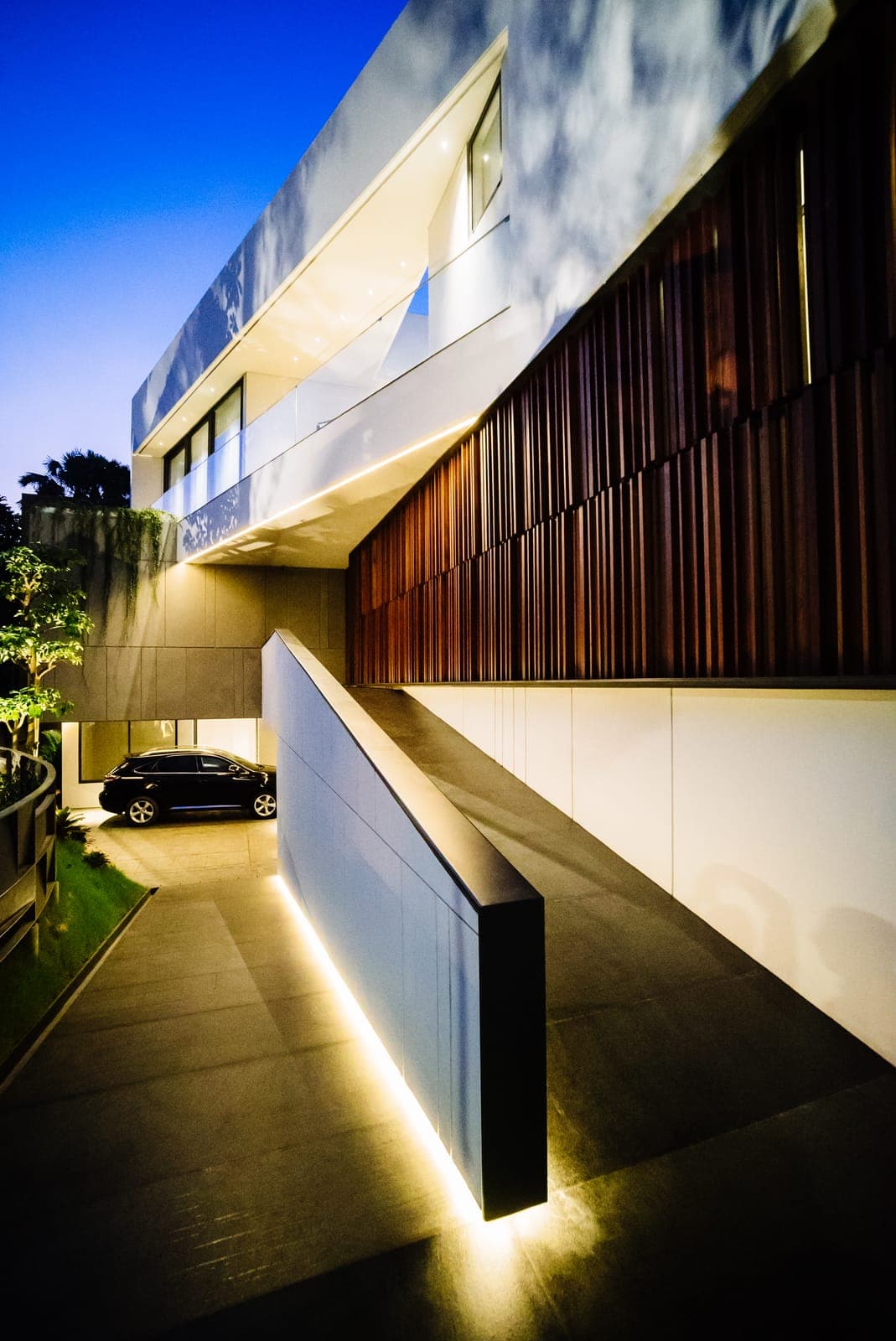 The street elevation — timber screening above a stone base.