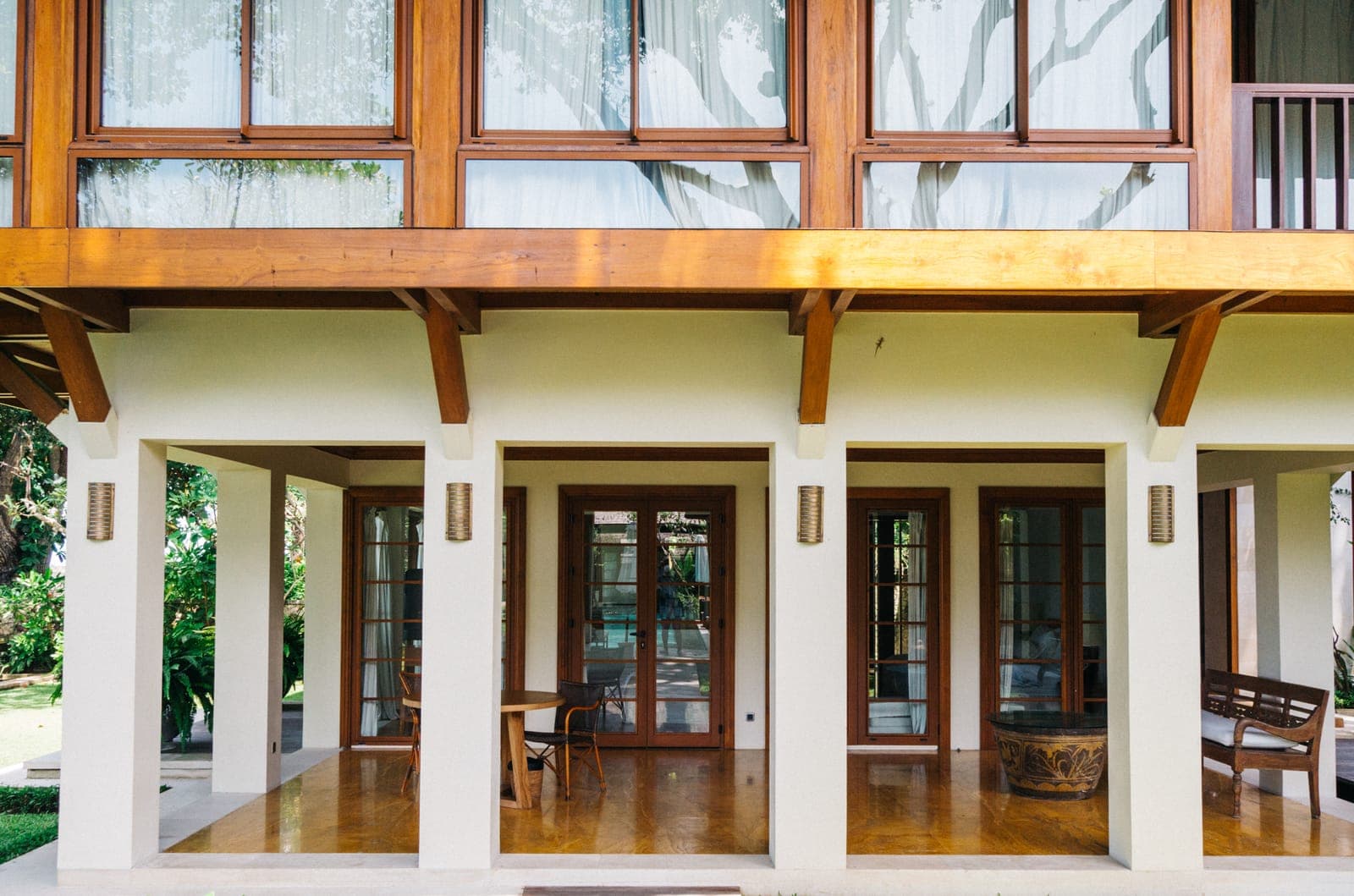 Glazing wall to wall above the columns, framed to match the timber.