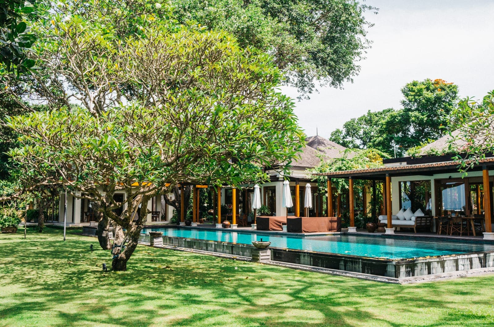 The villa across the lawn, pool down one side.