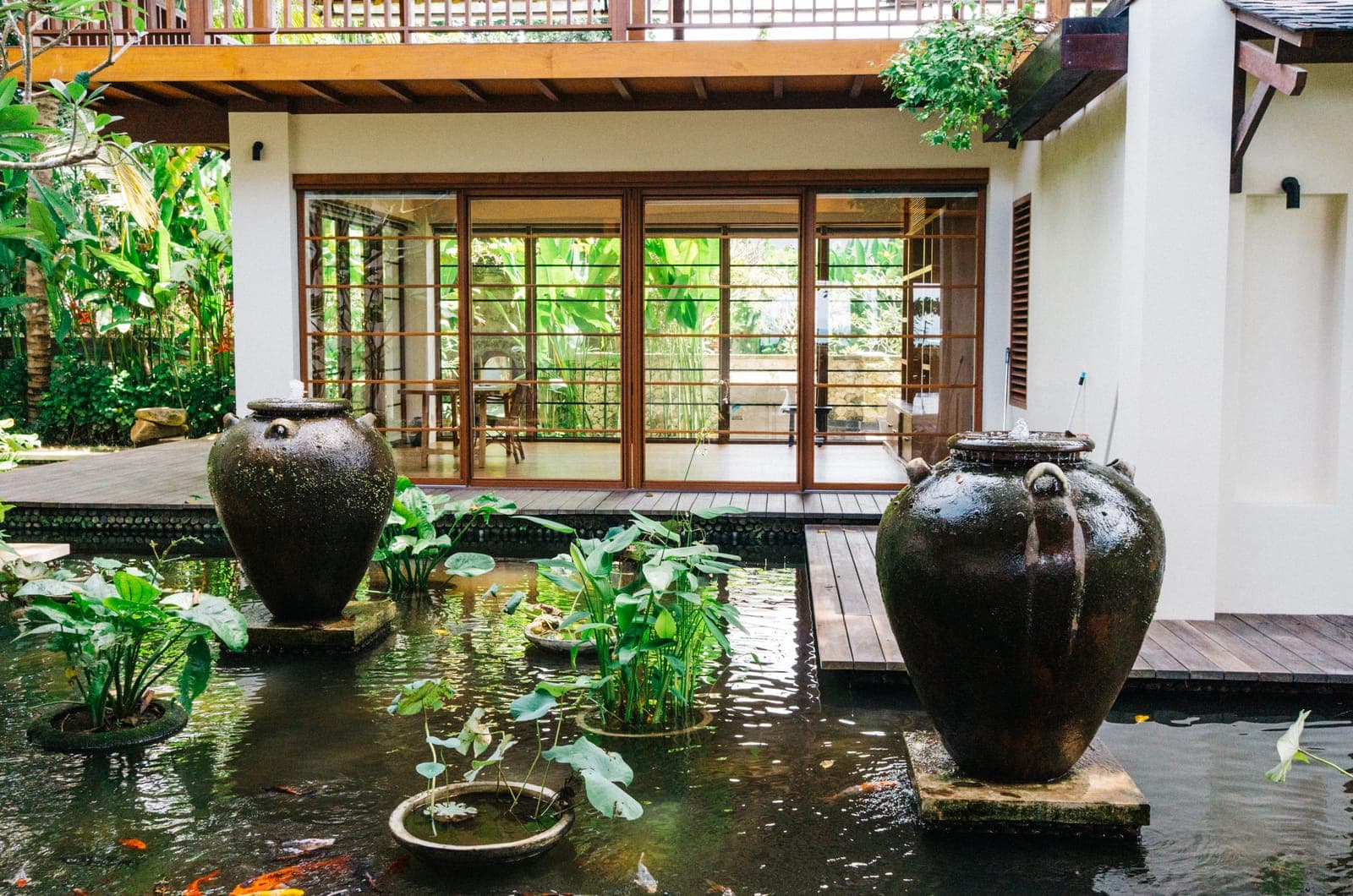 Lily pond and jars at the foot of the wall.