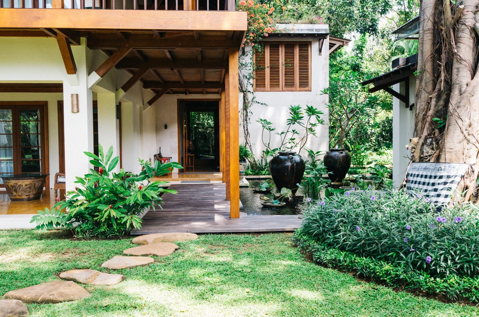 Stepping stones to the entrance, under the banyan.