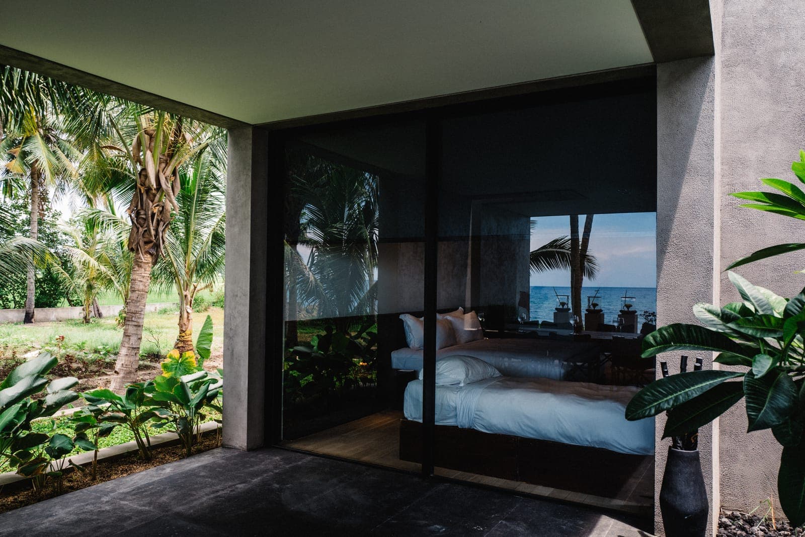 A bedroom opened to the garden on frameless Invisi sliding.