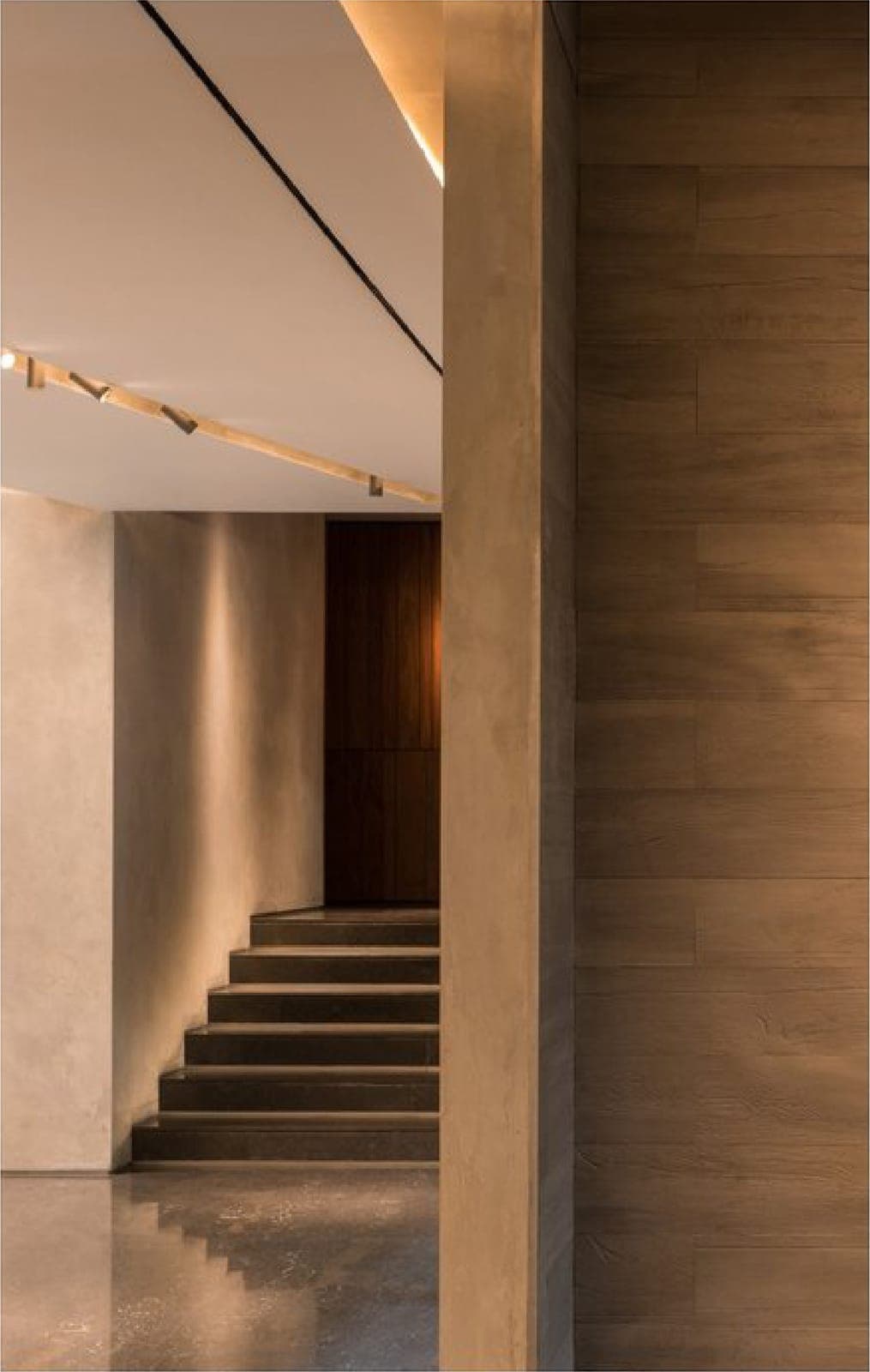 The entrance — brass lettering on a timber wall.