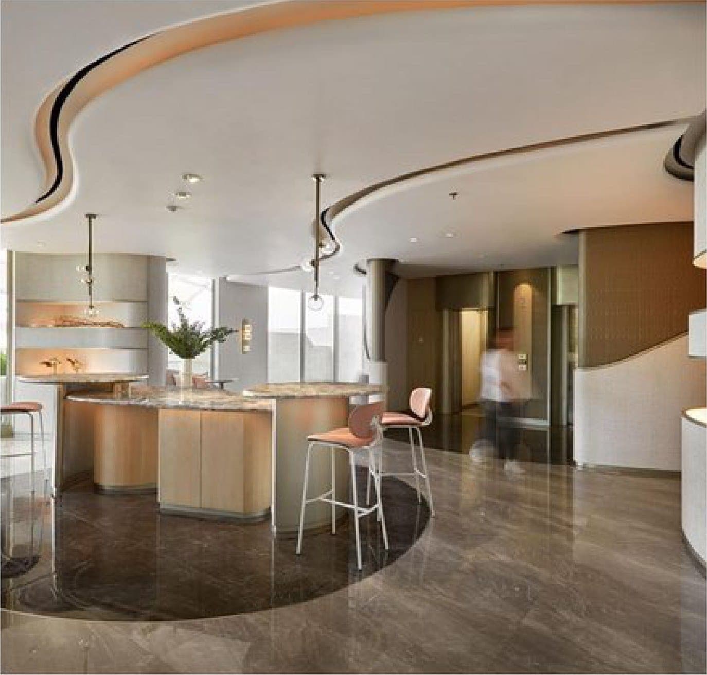 The arrival lounge, under a poured, curving ceiling.