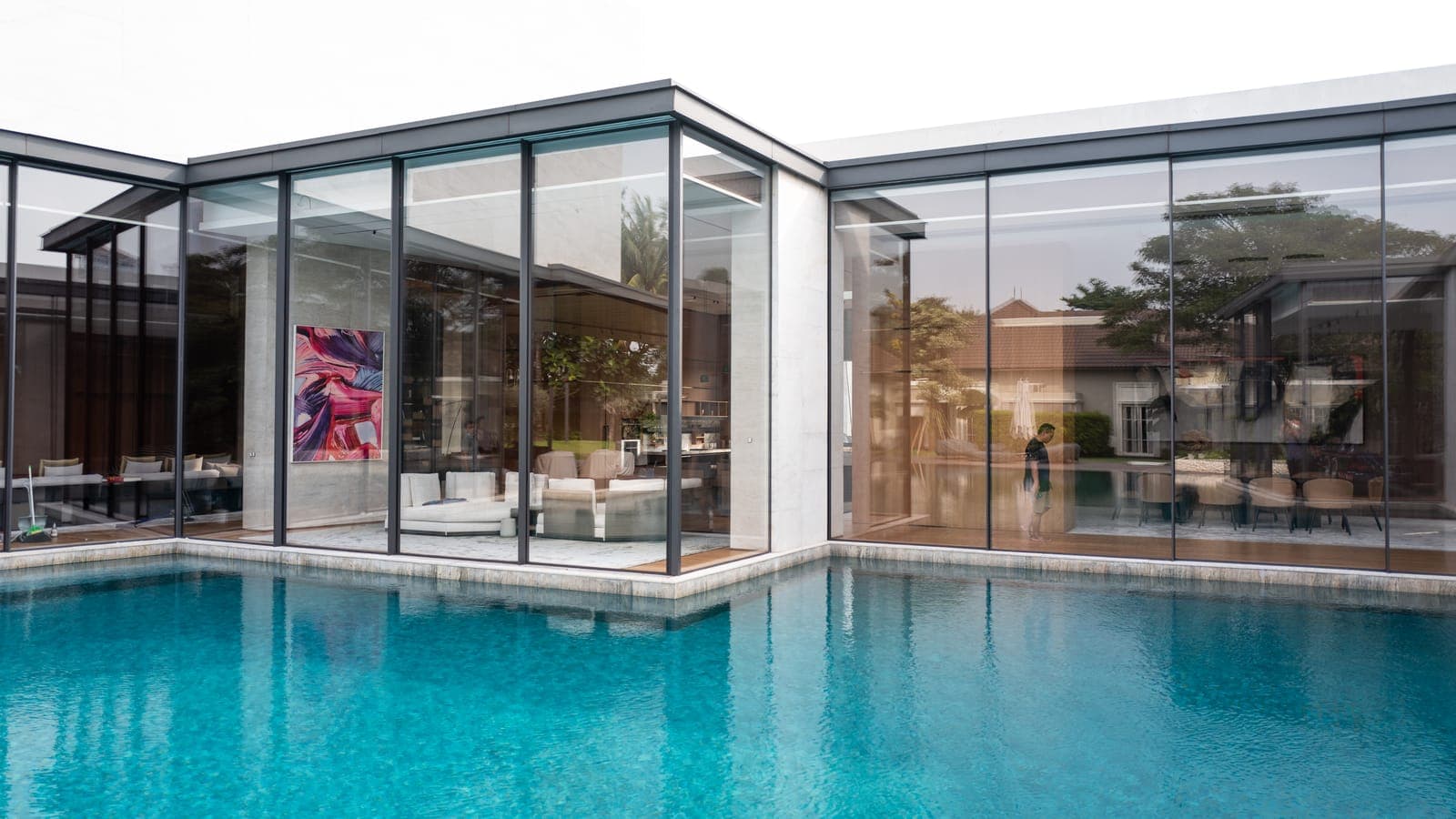 The pool elevation — glazing unbroken beneath a deep eave.