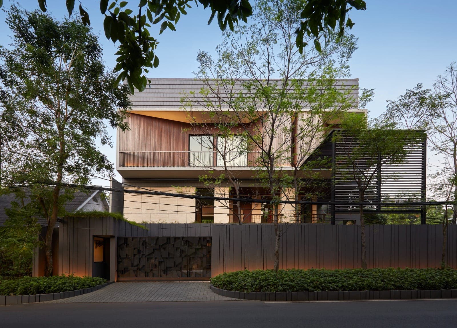 The street elevation, behind the trees left standing.