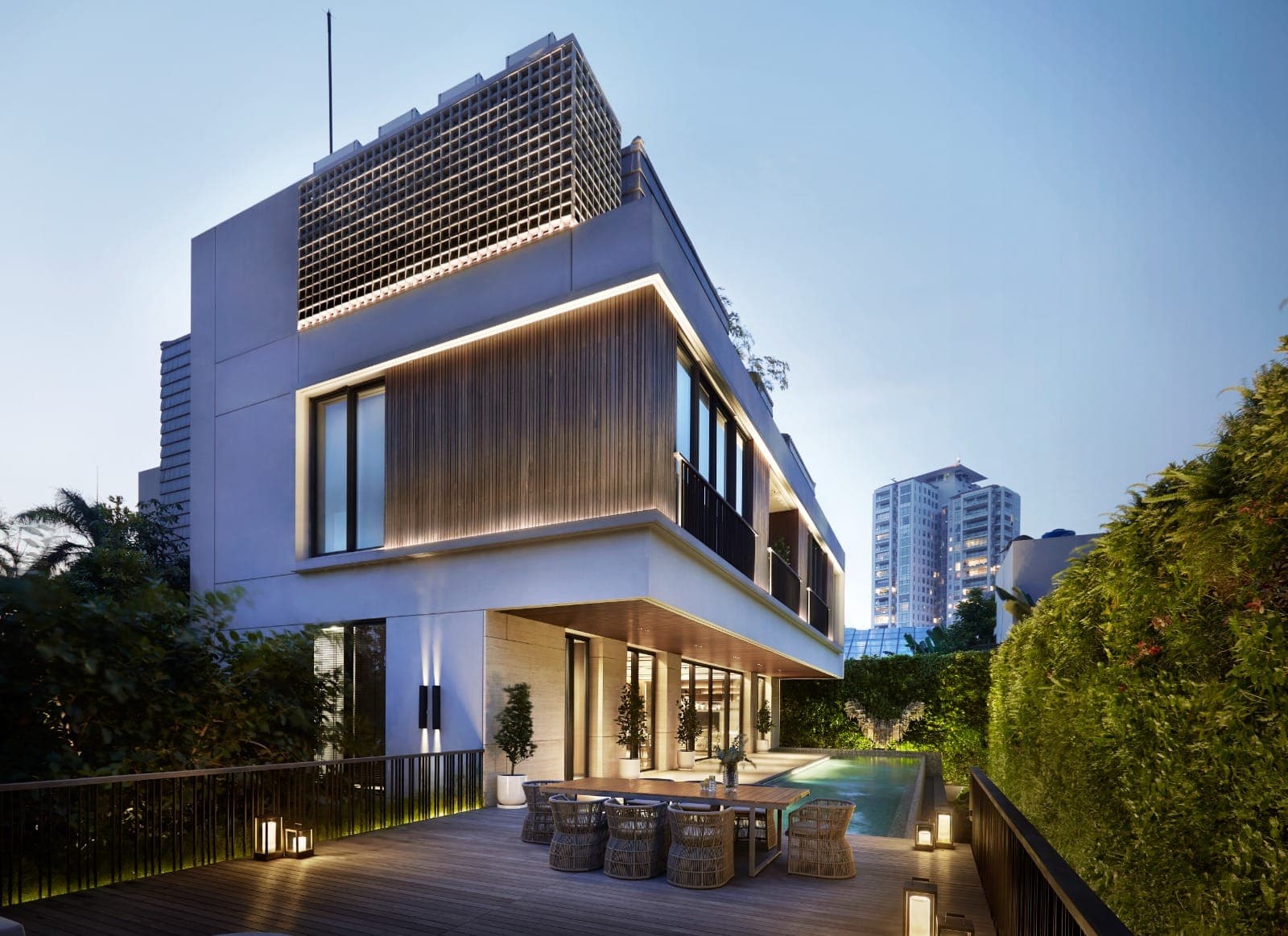 From the pool terrace at dusk — the upper floor carried out over the garden.
