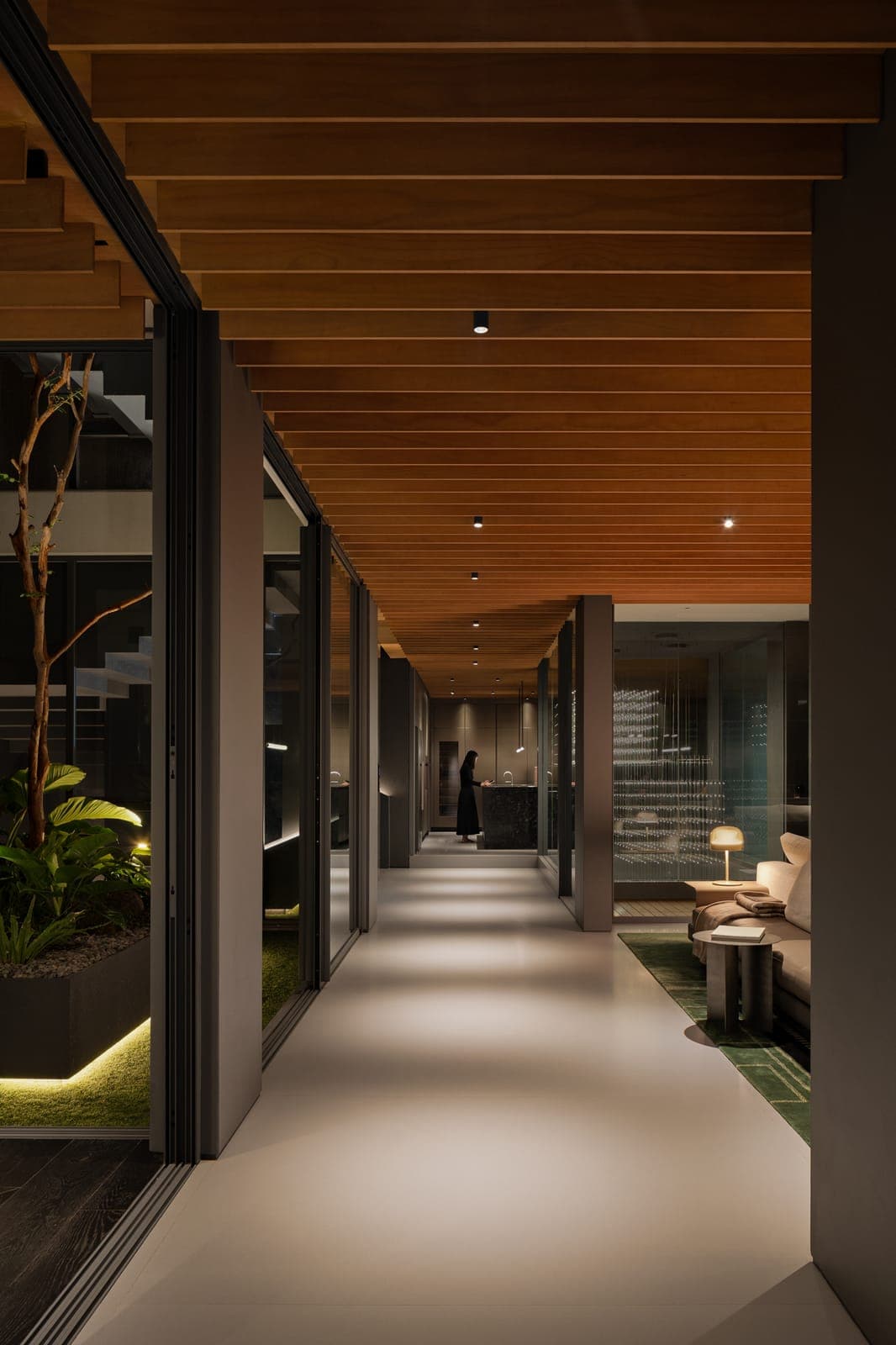 The corridor under its timber ceiling, court glazing folded back.